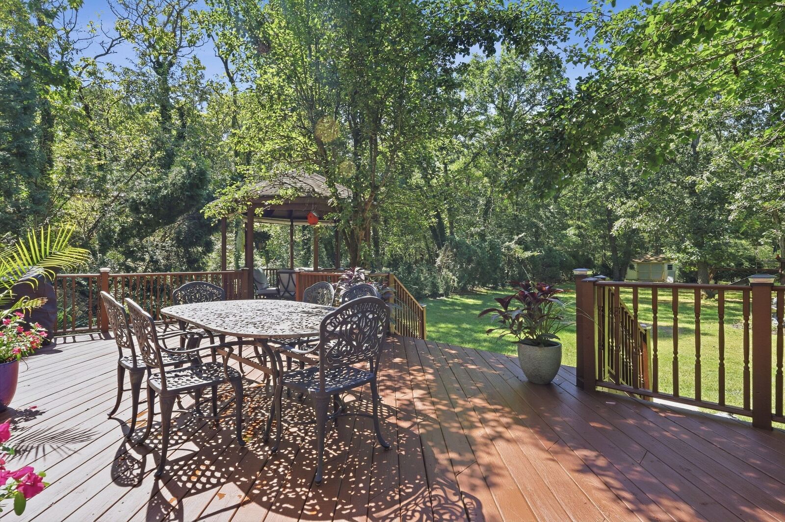 Multi-level rear deck with a cedar gazebo surrounded by mature trees